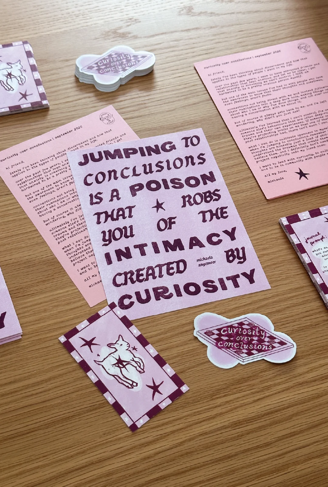 Pitter Patter’s September mail with a purple poetry print about curiosity, a matching letter, bookmarks and stickers.