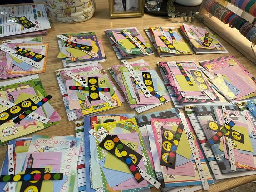 April Yes Junk Mail Club bundles with colorful paper scraps and smiley-face stickers