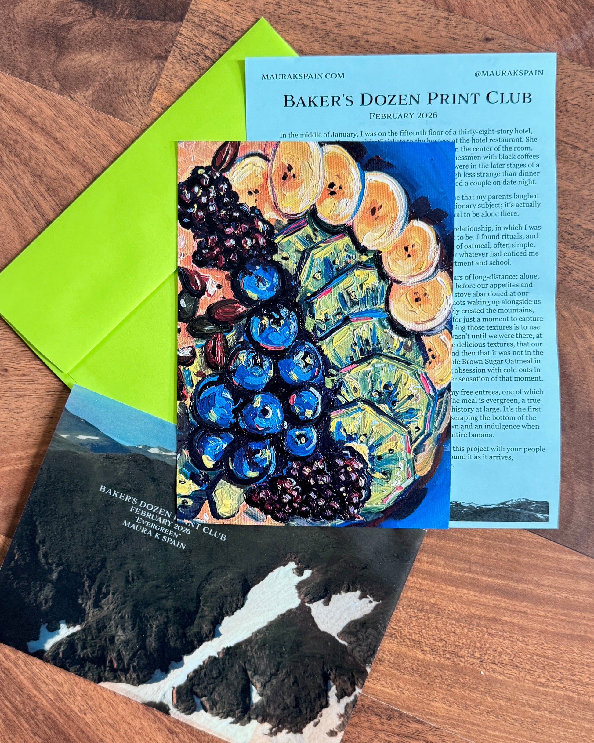 February 2026 fruit and oatmeal art print with a personal letter, mountain-photo sleeve and green envelope