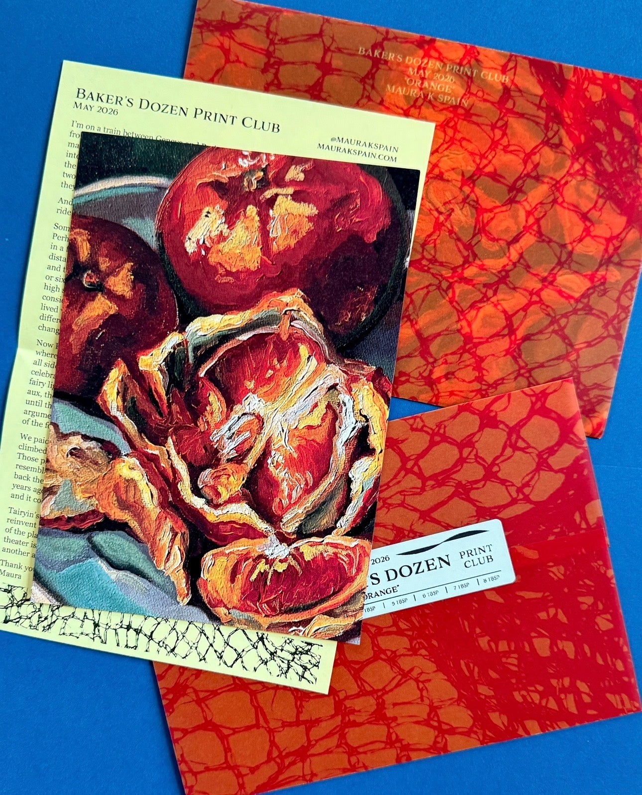 May 2026 orange art print with a personal letter and matching orange patterned paper sleeve