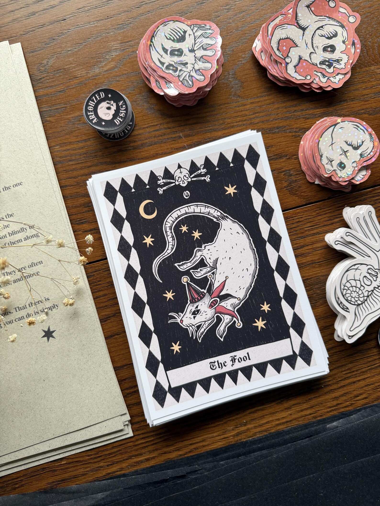 Dark Moon April edition — The Fool tarot print and pink skull stickers beside a letter