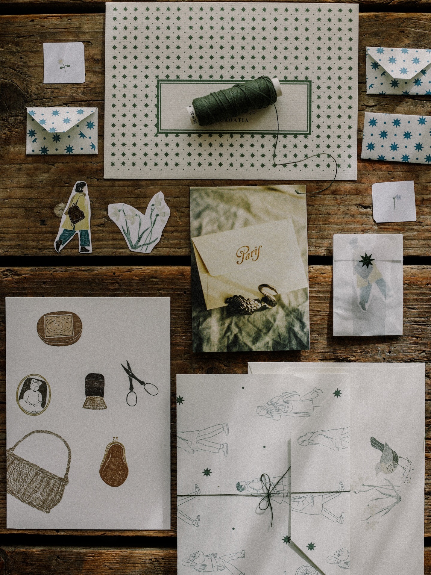 Meadow Letters: Star-patterned envelopes, illustrated paper goods, stickers, and a Paris photo card arranged on wood