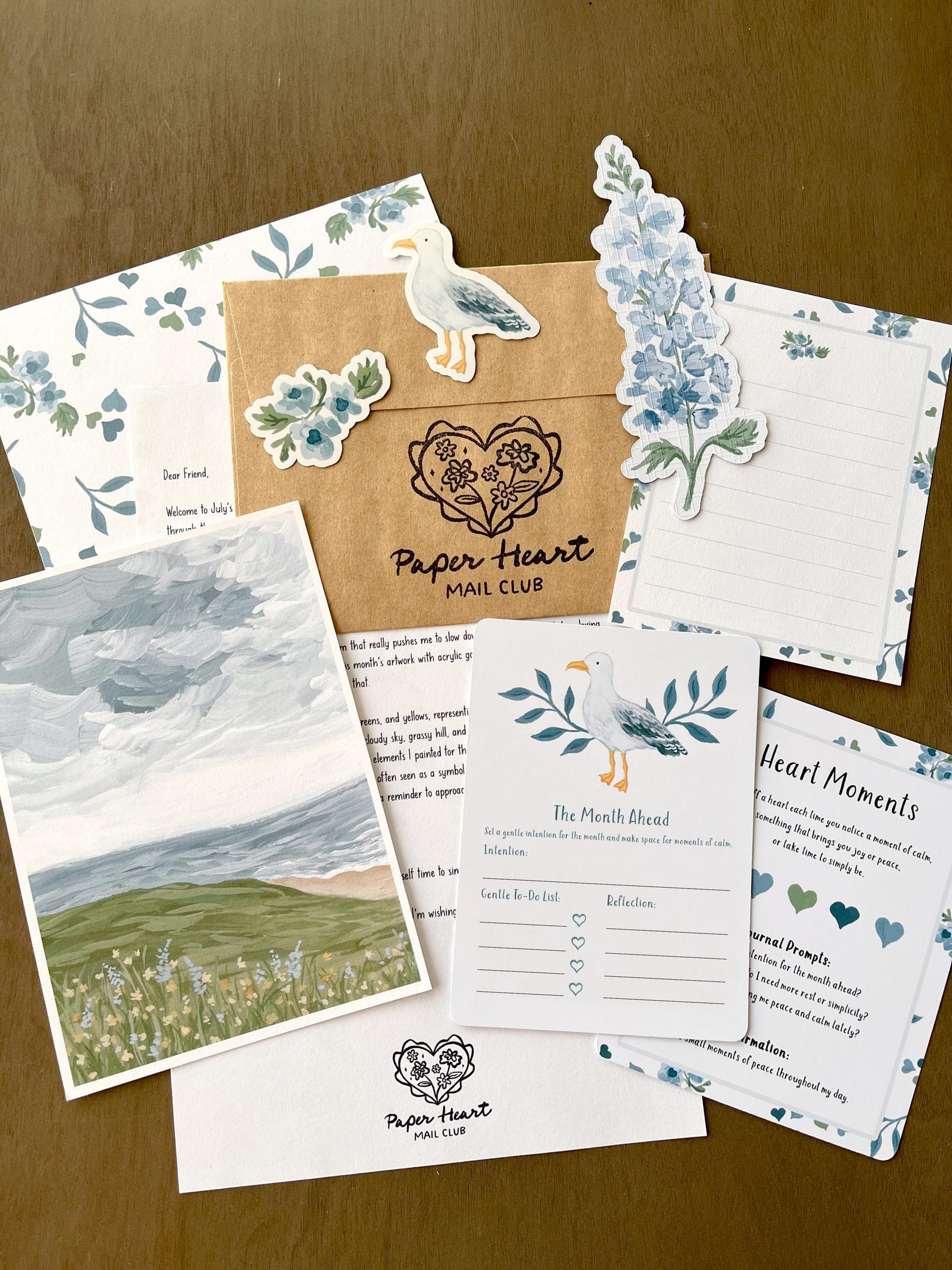 Paper Heart Mail Club — July single mail set with a landscape print, floral bookmark, stickers, letter, and reflection cards