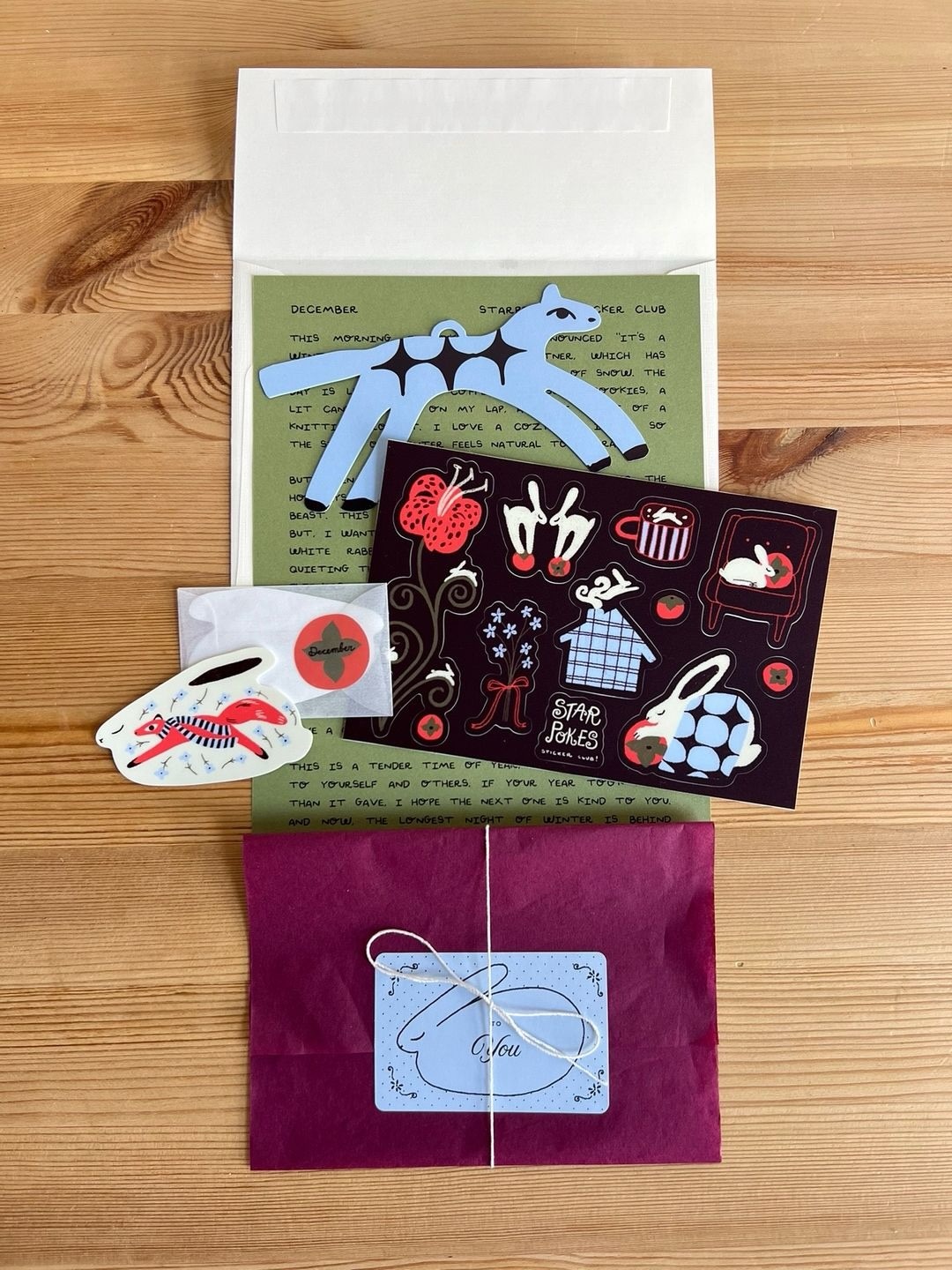 Starpokes December mail with a letter, envelope, animal stickers, sticker sheet and wrapped paper item
