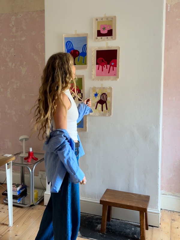 Charlie Rose looking at artwork in her studio
