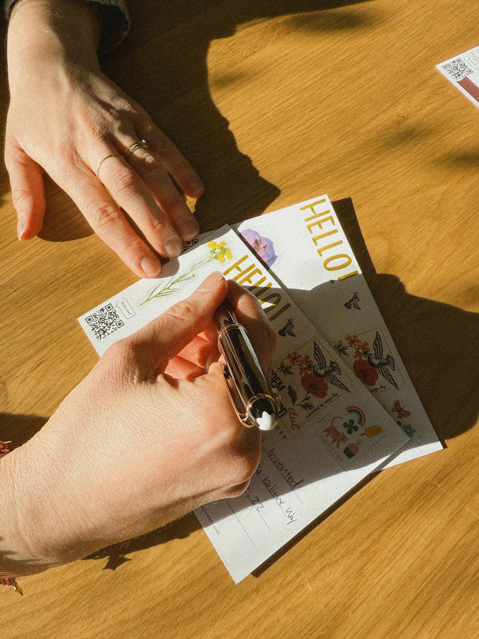 Poem Postcard Club — Elise writing on the reverse of a postcard