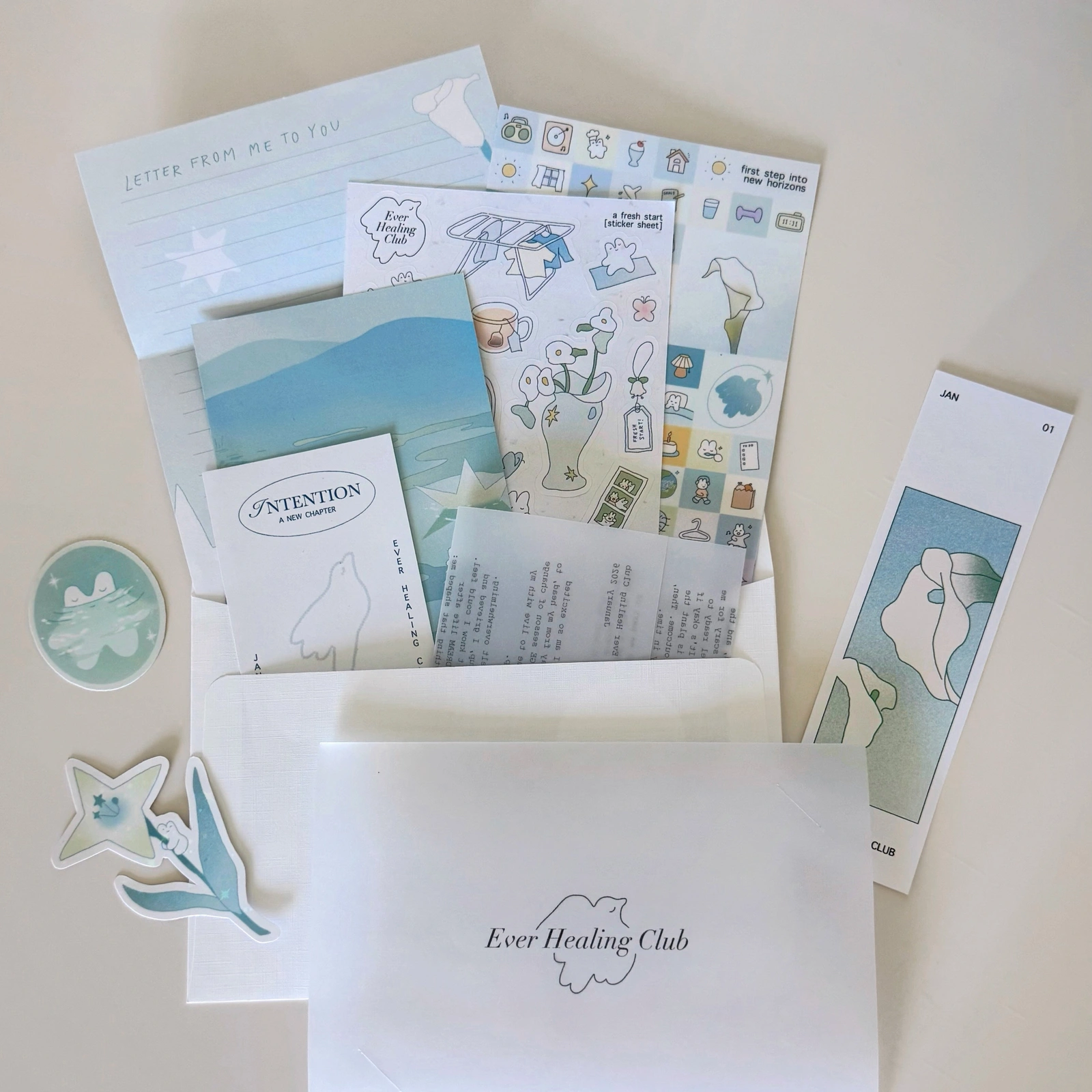 Ever Healing Club: January Signature edition with postcard, stickers, letter, intentions card, and bookmark