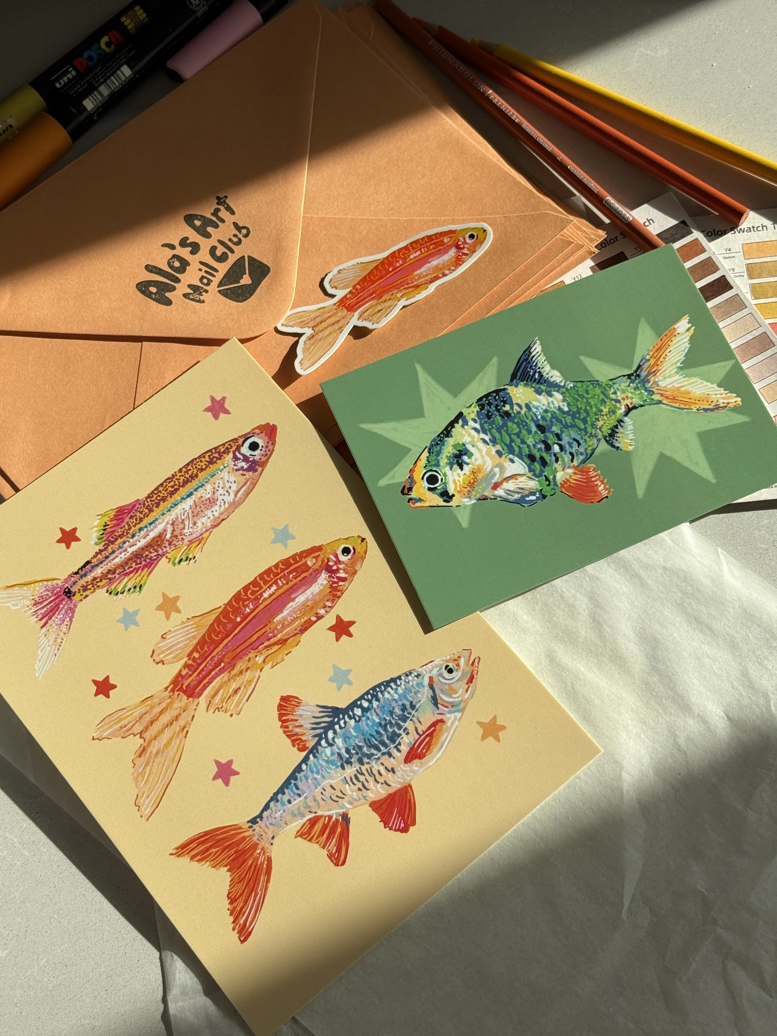 Art Mail Club — June 2026 fish prints with sticker and envelope